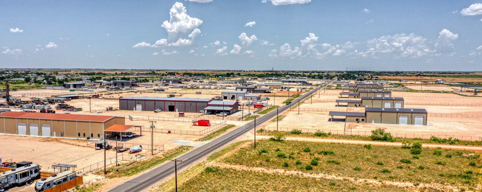 County Road 140 and the industrial yards south of Midland under a big West Texas sky