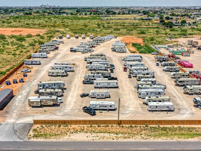 Rows of RVs parked on level caliche spots at Rangers RV Park